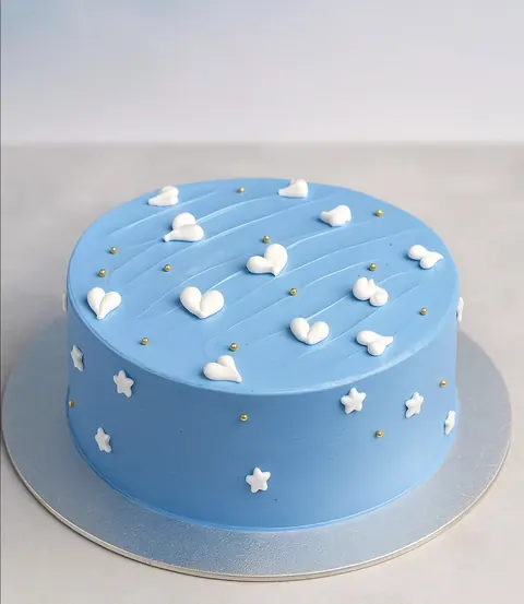 A tall cake with blue and white swirls and gold leaf