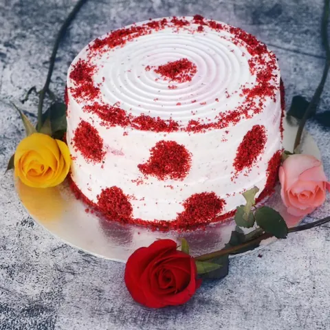 A red velvet cake topped with red roses